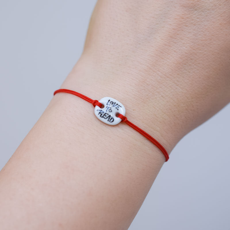 Love to read Porcelain bracelet handmade and hand painted by Vali Bondoc. Bratara din portelan modelata si pictata manual de Vali Bondoc