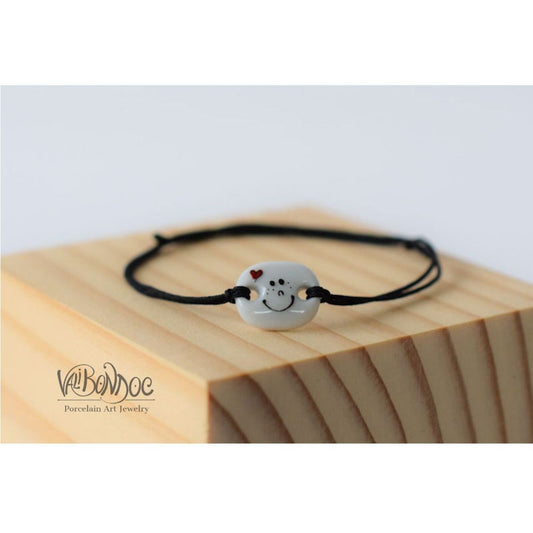 Smiley face with heart .Porcelain bracelet handmade and hand painted by Vali Bondoc