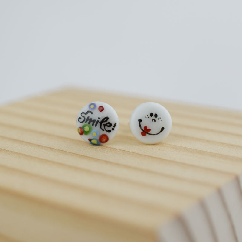 Porcelain stud earrings created and hand-painted by Vali Bondoc with high temperature ceramic dyes 