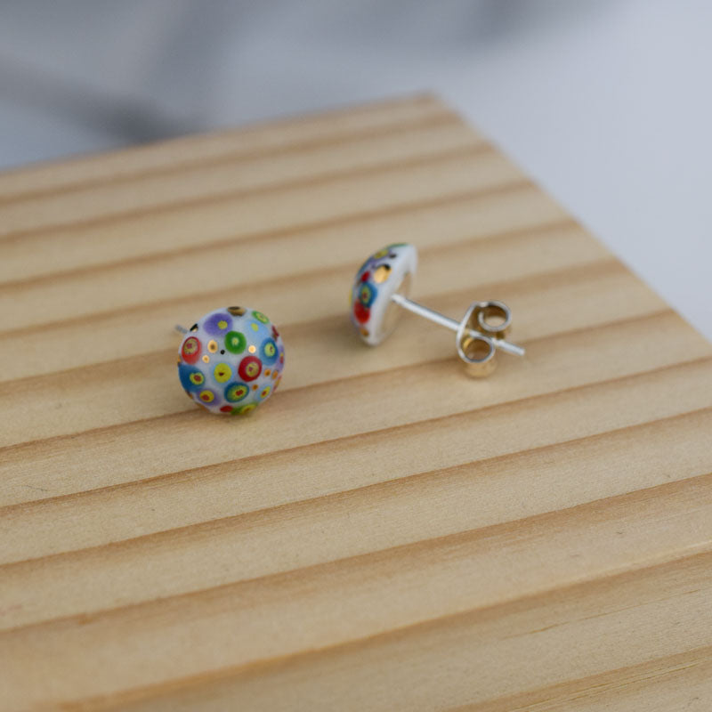 Porcelain stud earrings created and hand-painted by Vali Bondoc with high temperature ceramic dyes and colloidal gold
