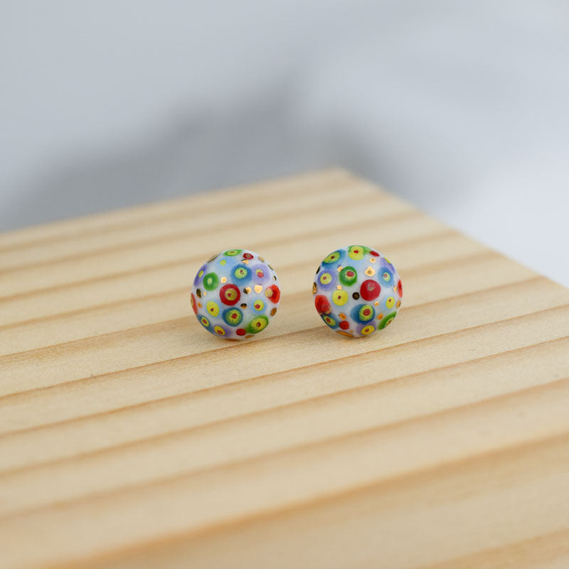 Porcelain stud earrings created and hand-painted by Vali Bondoc with high temperature ceramic dyes and colloidal gold