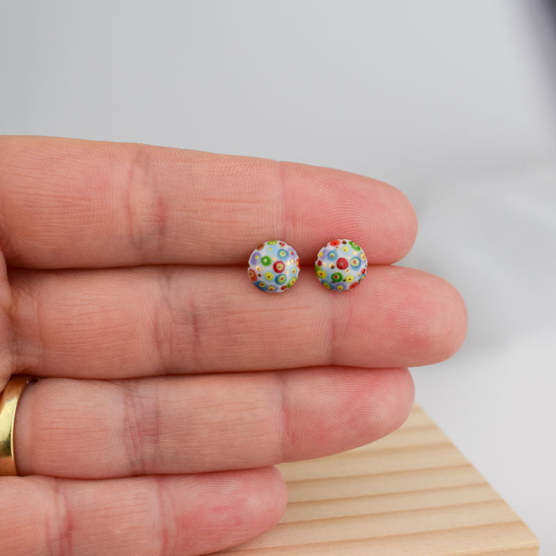 Porcelain stud earrings created and hand-painted by Vali Bondoc with high temperature ceramic dyes and colloidal gold