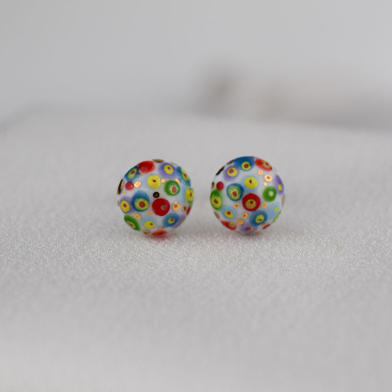 Porcelain stud earrings created and hand-painted by Vali Bondoc with high temperature ceramic dyes and colloidal gold