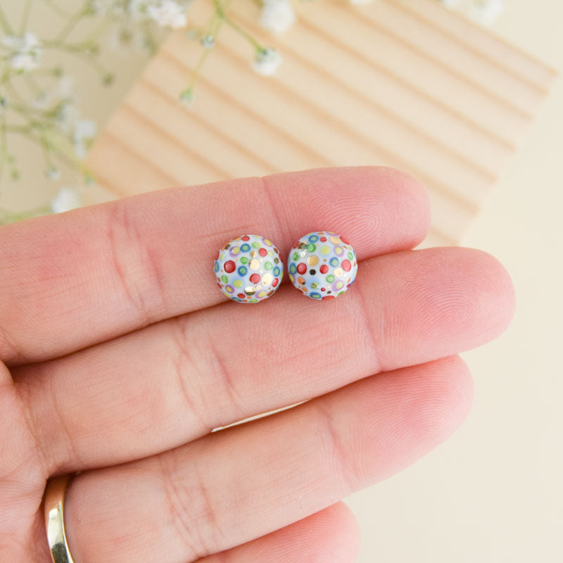 Porcelain stud earrings created and hand-painted by Vali Bondoc with high temperature ceramic dyes and colloidal gold