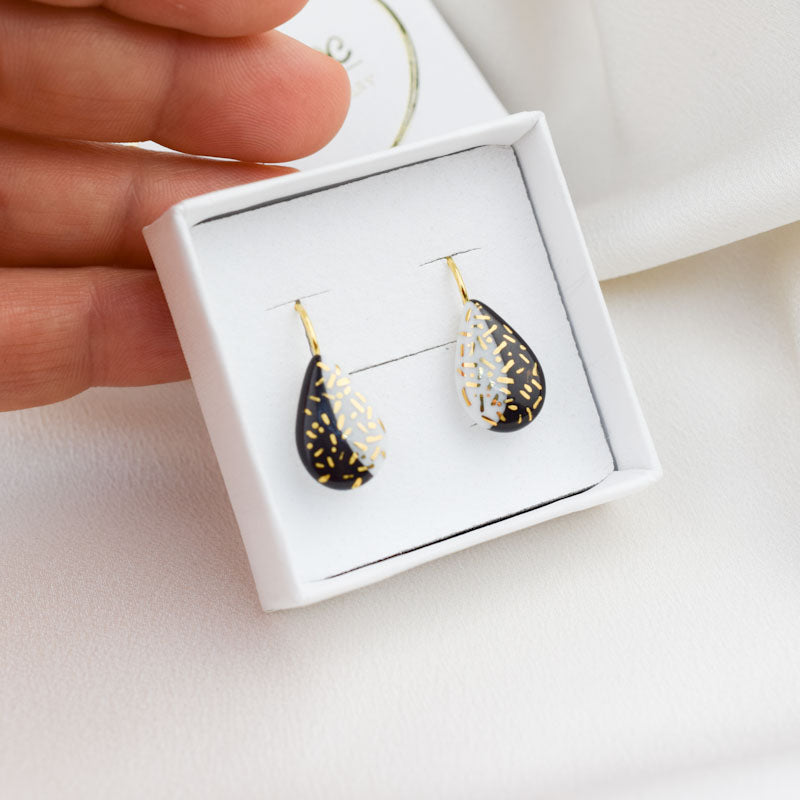 Porcelain hook earrings created and hand-painted by Vali Bondoc with high temperature ceramic dyes and colloidal gold