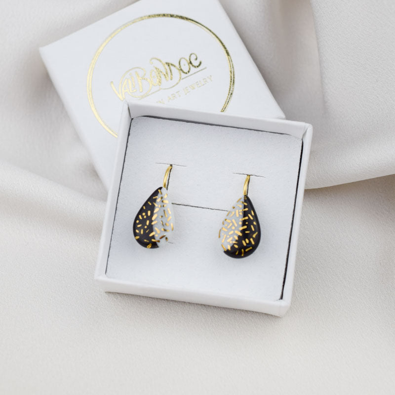 Porcelain hook earrings created and hand-painted by Vali Bondoc with high temperature ceramic dyes and colloidal gold