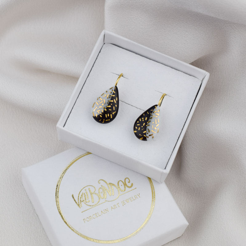 Porcelain hook earrings created and hand-painted by Vali Bondoc with high temperature ceramic dyes and colloidal gold