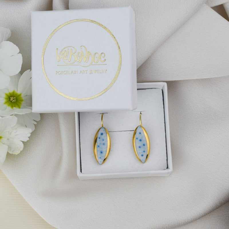Porcelain hook earrings created and hand-painted by Vali Bondoc with high temperature ceramic dyes and colloidal gold