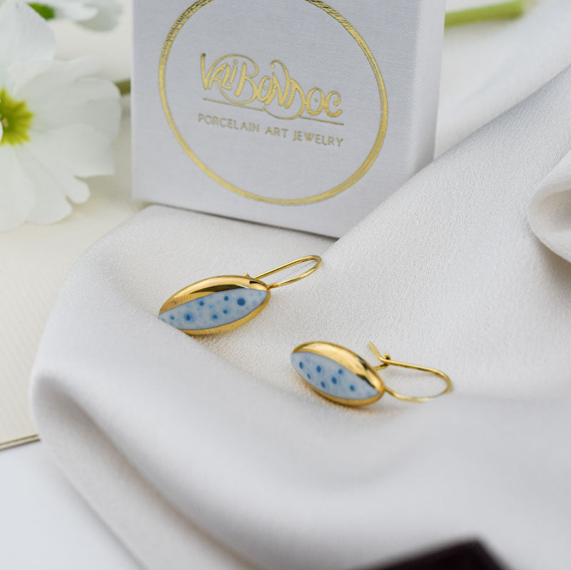 Porcelain stud earrings created and hand-painted by Vali Bondoc with high temperature ceramic dyes and colloidal gold
