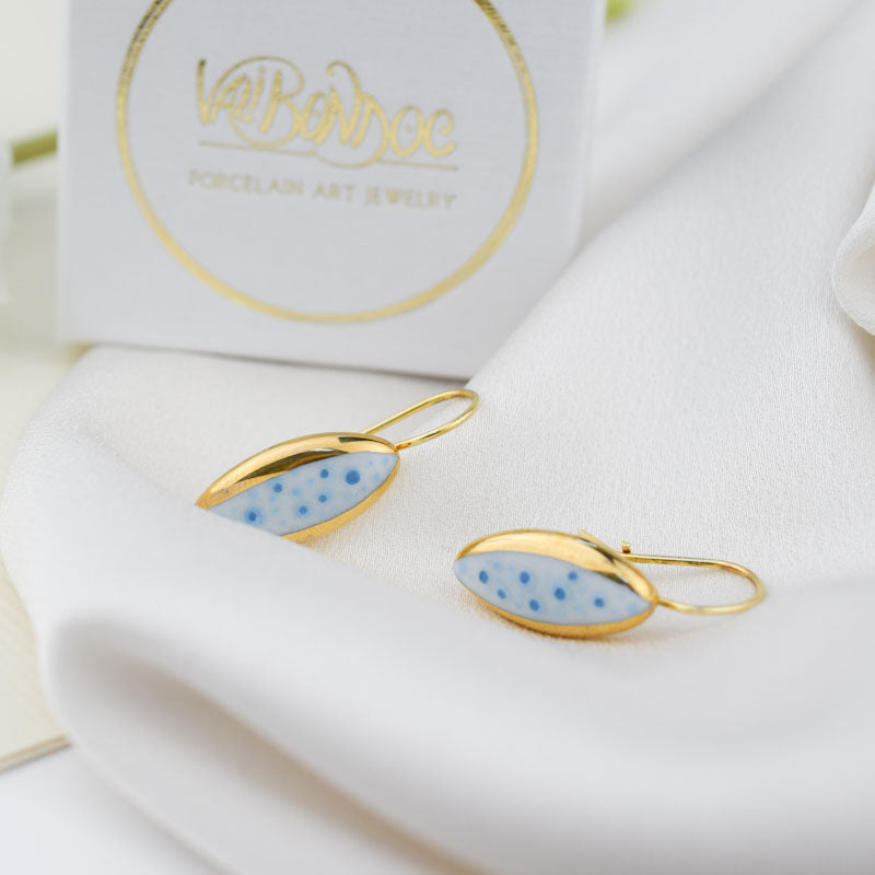 Porcelain stud earrings created and hand-painted by Vali Bondoc with high temperature ceramic dyes and colloidal gold