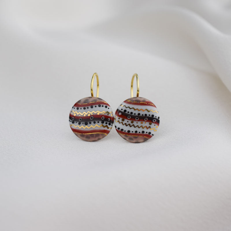 Porcelain hook earrings created and hand-painted by Vali Bondoc with high temperature ceramic dyes and colloidal gold