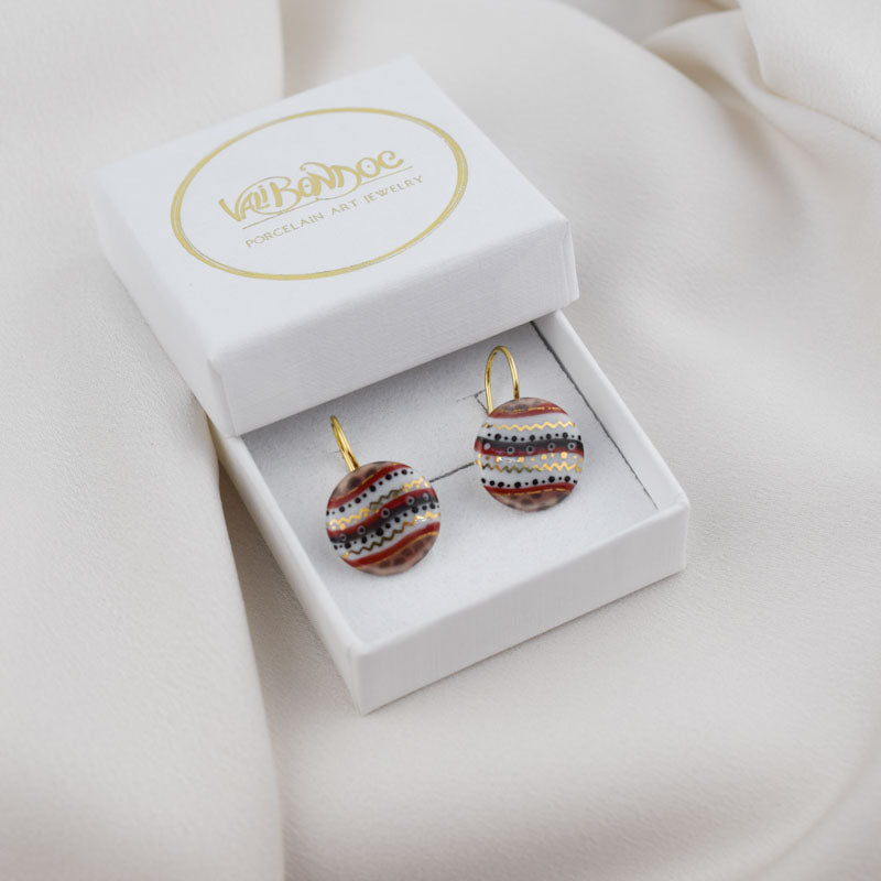 Porcelain hook earrings created and hand-painted by Vali Bondoc with high temperature ceramic dyes and colloidal gold