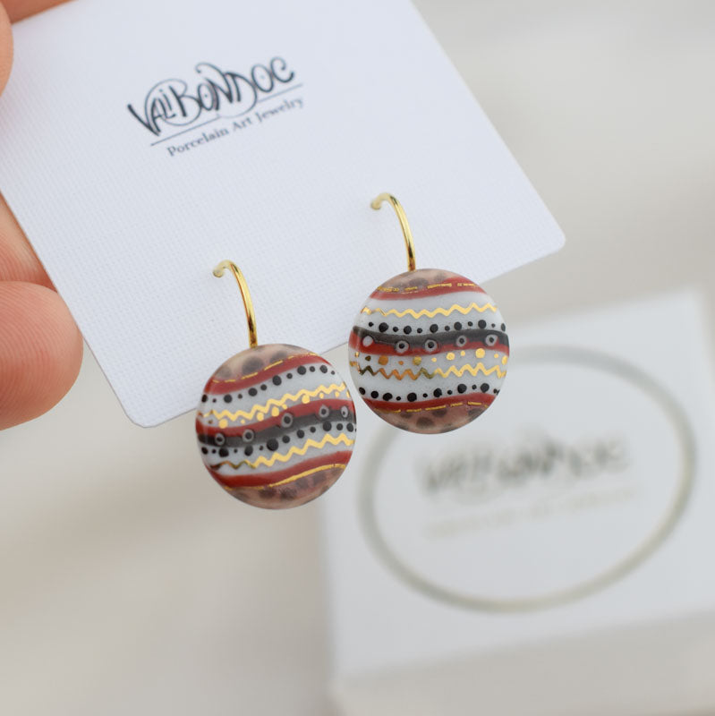 Porcelain hook earrings created and hand-painted by Vali Bondoc with high temperature ceramic dyes and colloidal gold