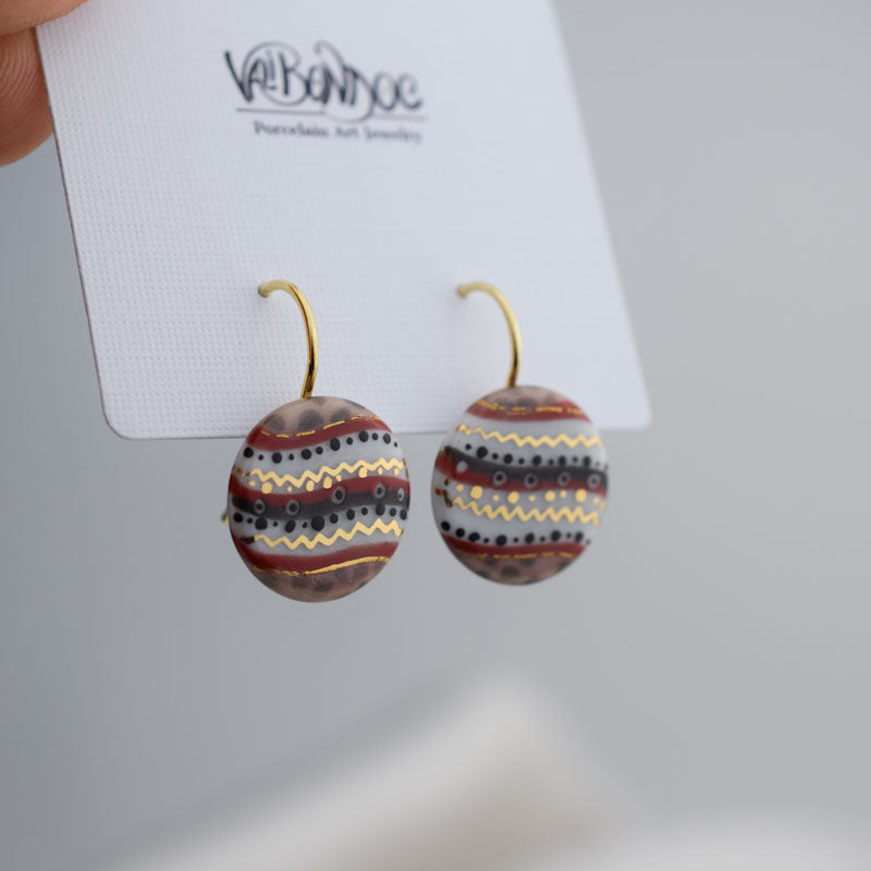 Porcelain hook earrings created and hand-painted by Vali Bondoc with high temperature ceramic dyes and colloidal gold