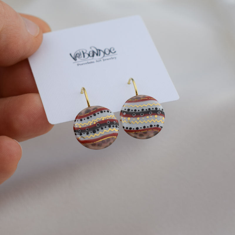 Porcelain hook earrings created and hand-painted by Vali Bondoc with high temperature ceramic dyes and colloidal gold