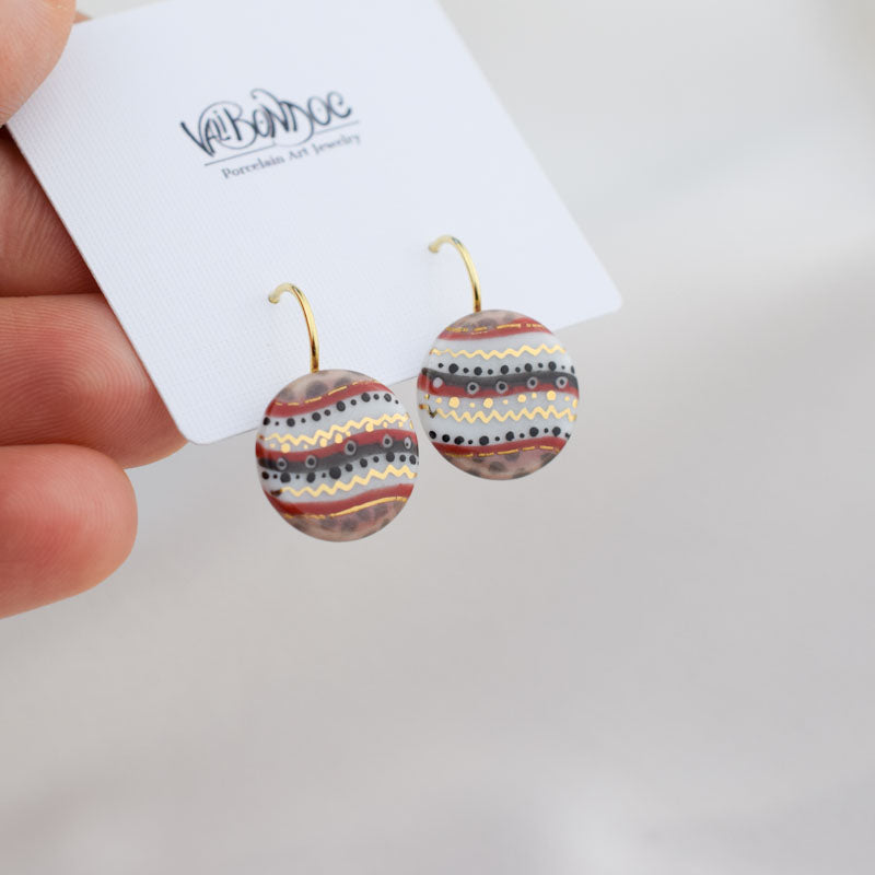 Porcelain hook earrings created and hand-painted by Vali Bondoc with high temperature ceramic dyes and colloidal gold