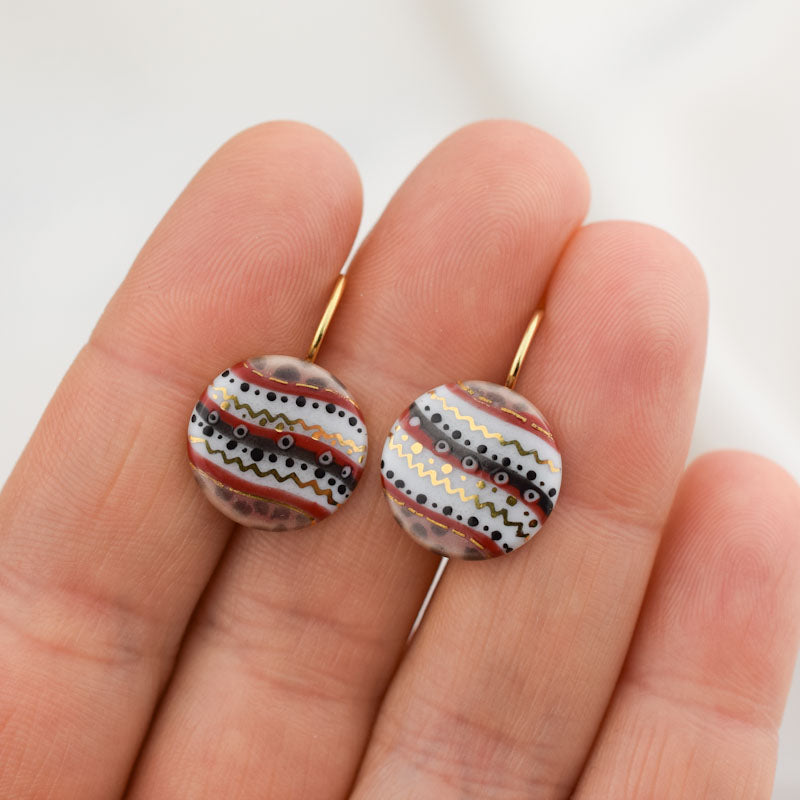 Porcelain hook earrings created and hand-painted by Vali Bondoc with high temperature ceramic dyes and colloidal gold