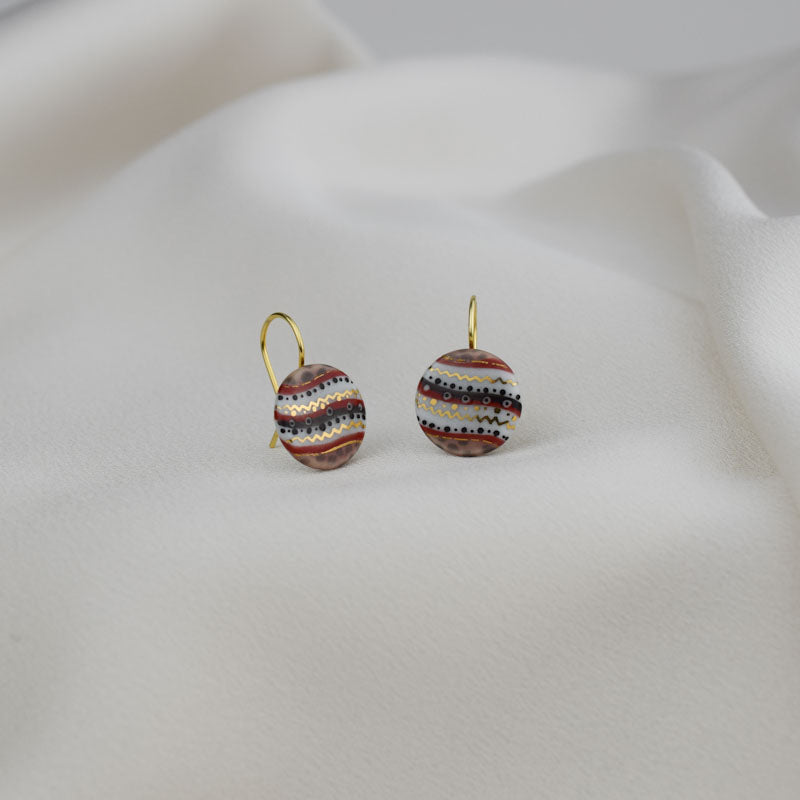 Porcelain hook earrings created and hand-painted by Vali Bondoc with high temperature ceramic dyes and colloidal gold