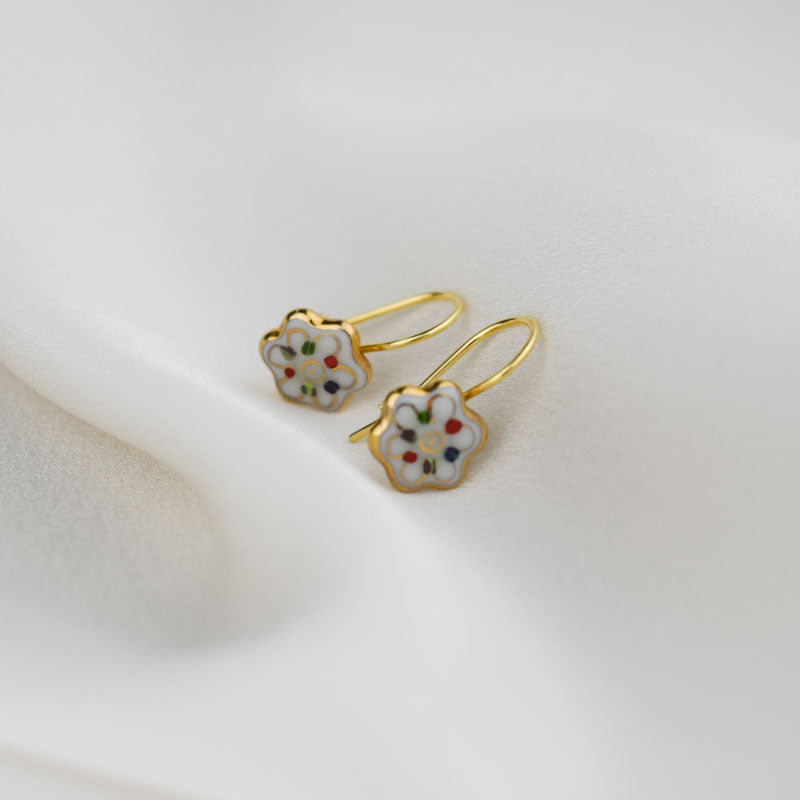 Porcelain hook earrings created and hand-painted by Vali Bondoc with high temperature ceramic dyes and colloidal gold