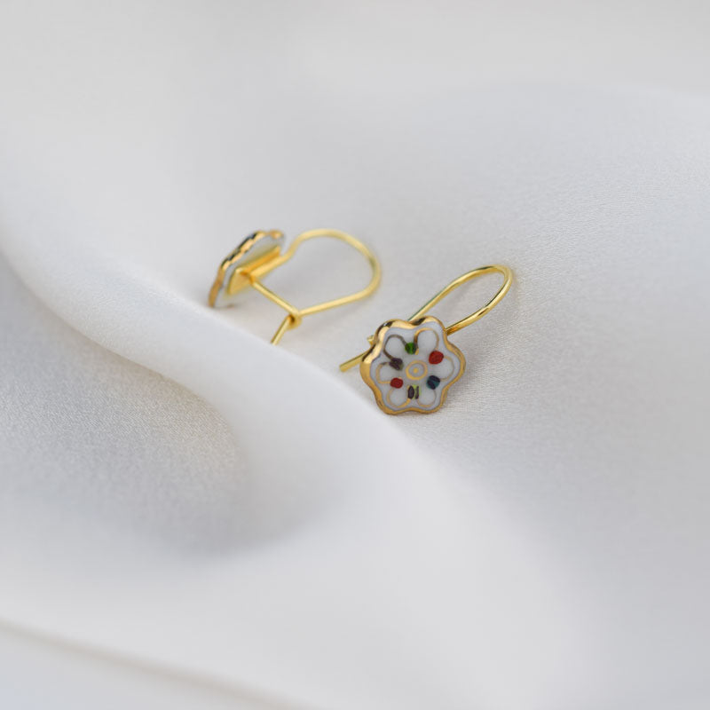 Porcelain hook earrings created and hand-painted by Vali Bondoc with high temperature ceramic dyes and colloidal gold