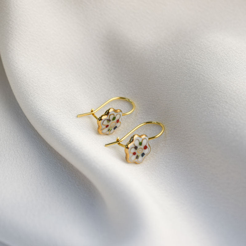 Porcelain hook earrings created and hand-painted by Vali Bondoc with high temperature ceramic dyes and colloidal gold