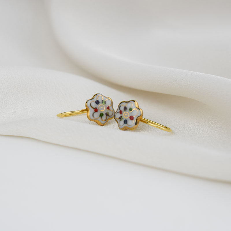 Porcelain hook earrings created and hand-painted by Vali Bondoc with high temperature ceramic dyes and colloidal gold