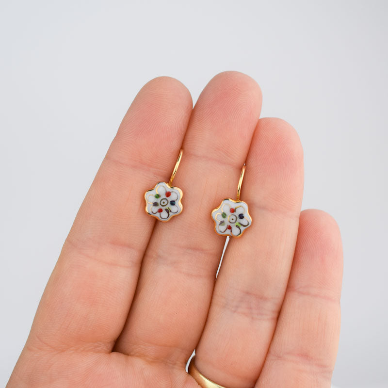 Porcelain hook earrings created and hand-painted by Vali Bondoc with high temperature ceramic dyes and colloidal gold
