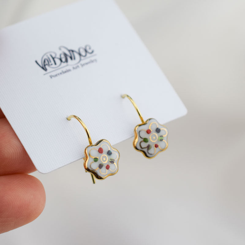Porcelain hook earrings created and hand-painted by Vali Bondoc with high temperature ceramic dyes and colloidal gold