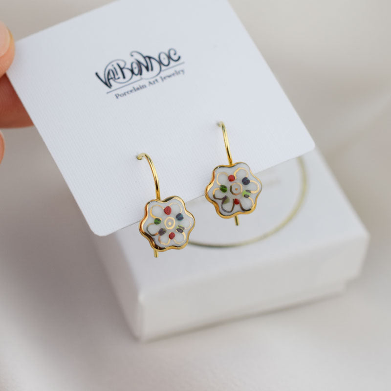 Porcelain hook earrings created and hand-painted by Vali Bondoc with high temperature ceramic dyes and colloidal gold