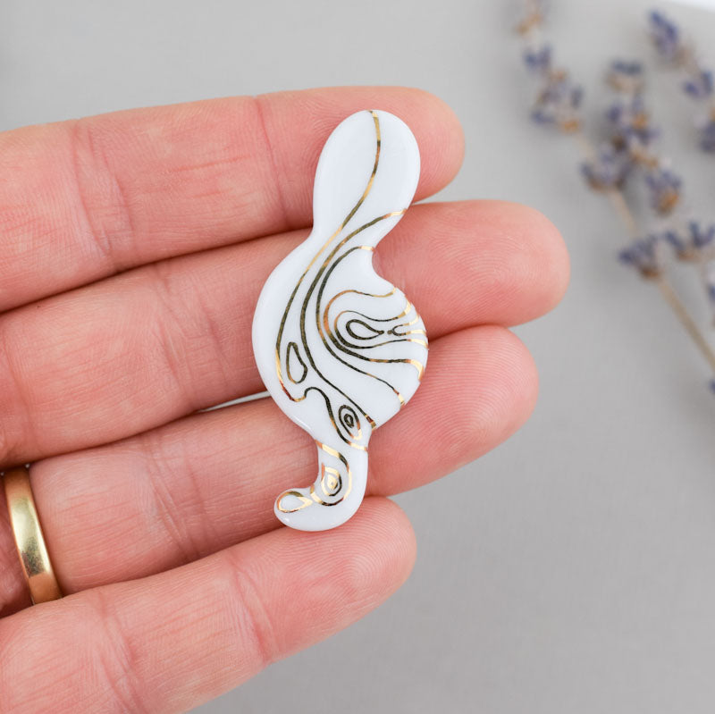 Porcelain brooch created and hand-painted by Vali Bondoc with high temperature ceramic dyes and colloidal gold.