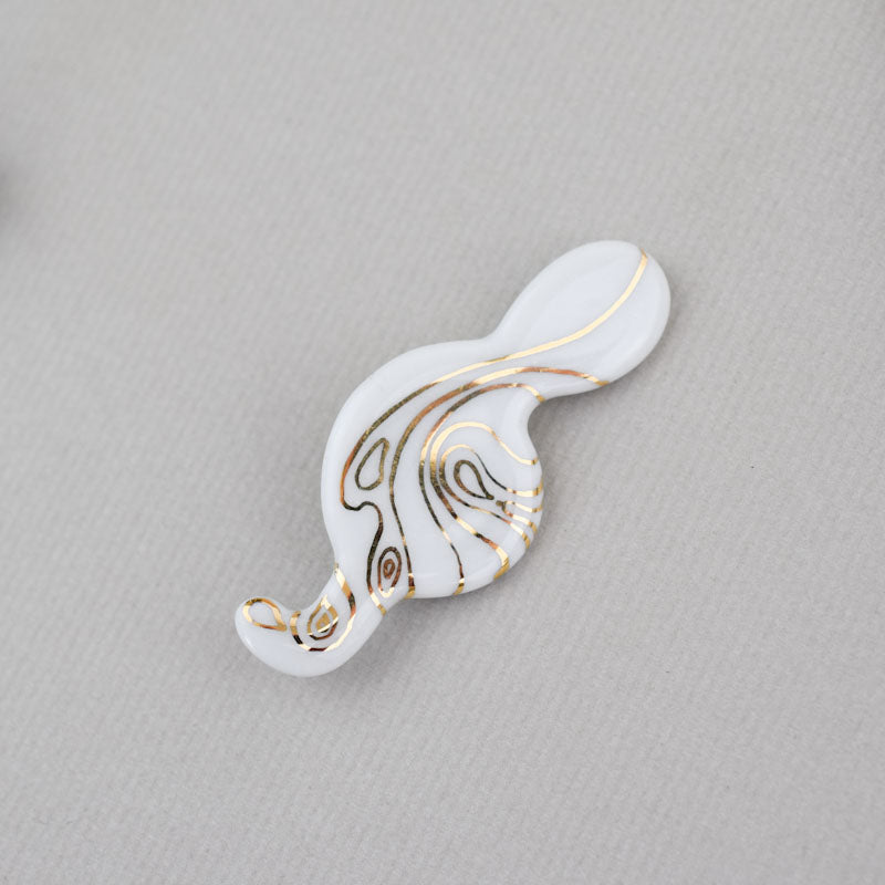 Porcelain brooch created and hand-painted by Vali Bondoc with high temperature ceramic dyes and colloidal gold.