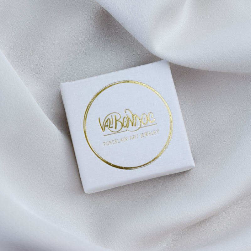 Porcelain brooch created and hand-painted by Vali Bondoc with high temperature ceramic dyes and colloidal gold.