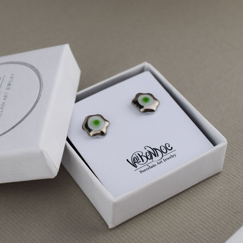 Porcelain stud earrings created and hand-painted by Vali Bondoc with high temperature ceramic dyes and colloidal gold