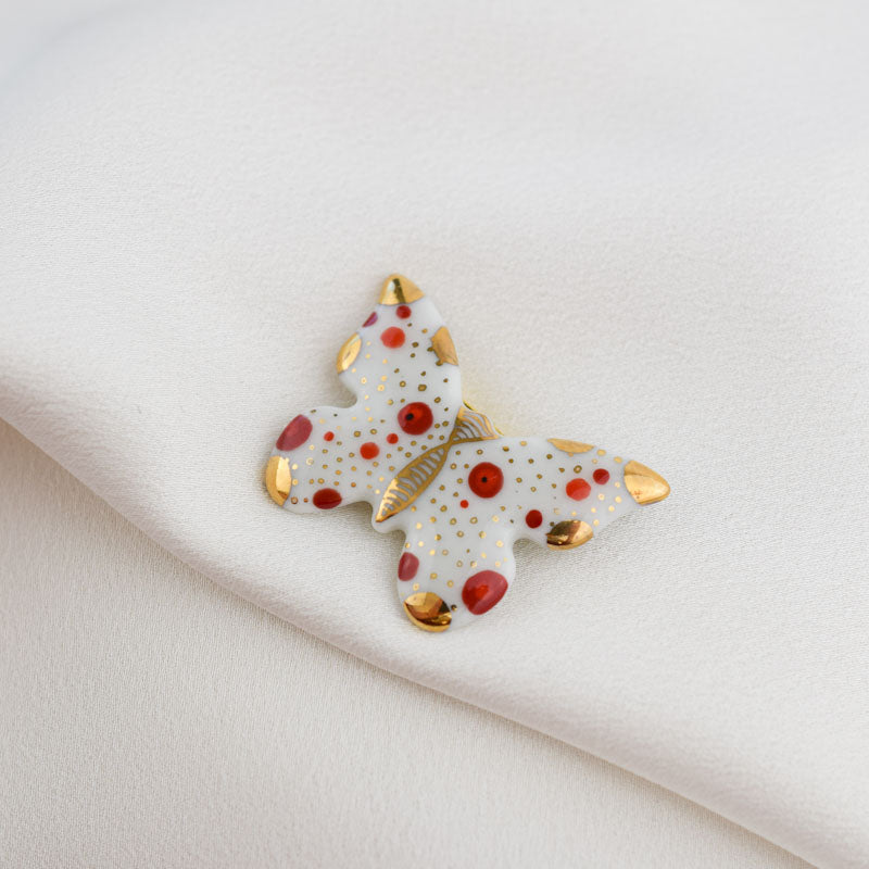 Butterfly. Porcelain brooch created and hand-painted by Vali Bondoc with high temperature ceramic dyes and colloidal gold