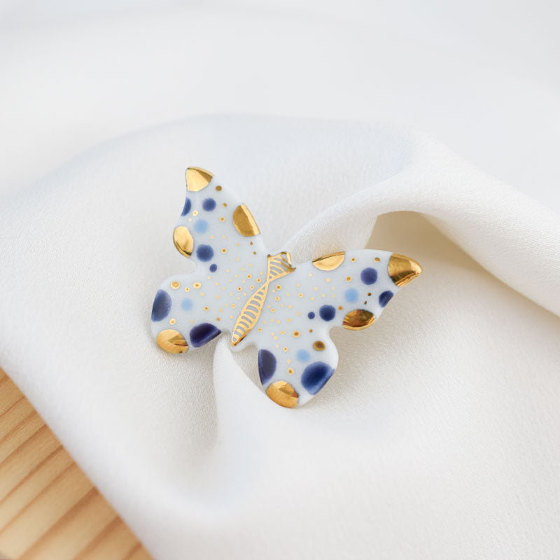 Butterfly. Porcelain brooch created and hand-painted by Vali Bondoc with high temperature ceramic dyes and colloidal gold