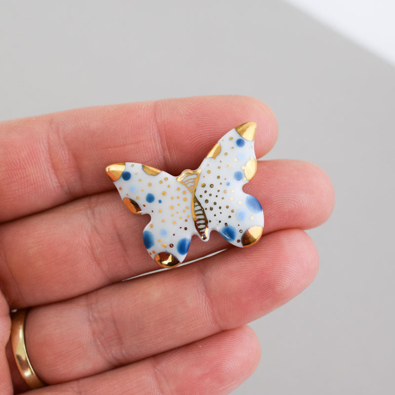 Butterfly. Porcelain brooch created and hand-painted by Vali Bondoc with high temperature ceramic dyes and colloidal gold