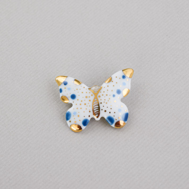 Butterfly. Porcelain brooch created and hand-painted by Vali Bondoc with high temperature ceramic dyes and colloidal gold
