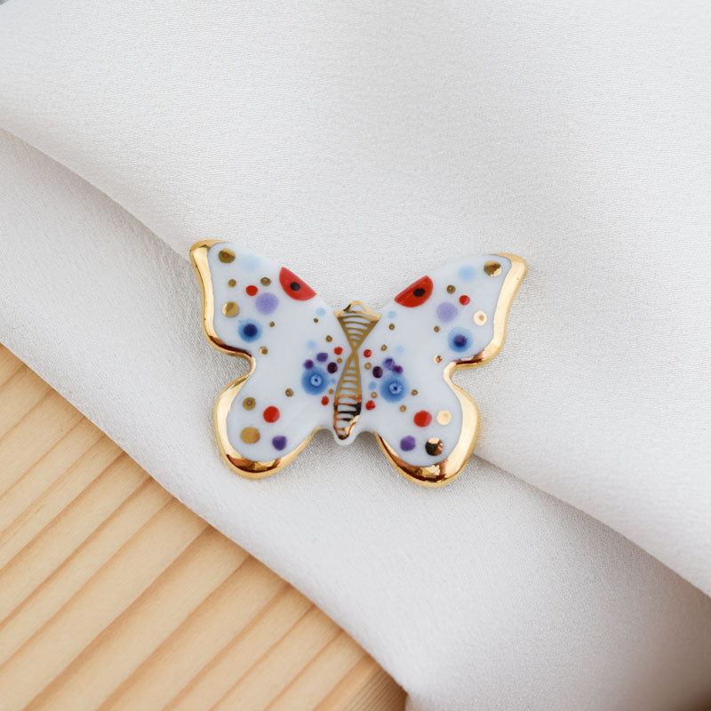 Butterfly. Porcelain brooch created and hand-painted by Vali Bondoc with high temperature ceramic dyes and colloidal gold