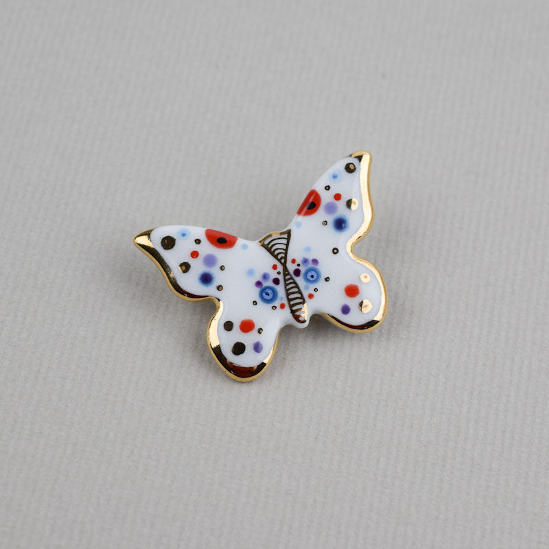 Butterfly. Porcelain brooch created and hand-painted by Vali Bondoc with high temperature ceramic dyes and colloidal gold