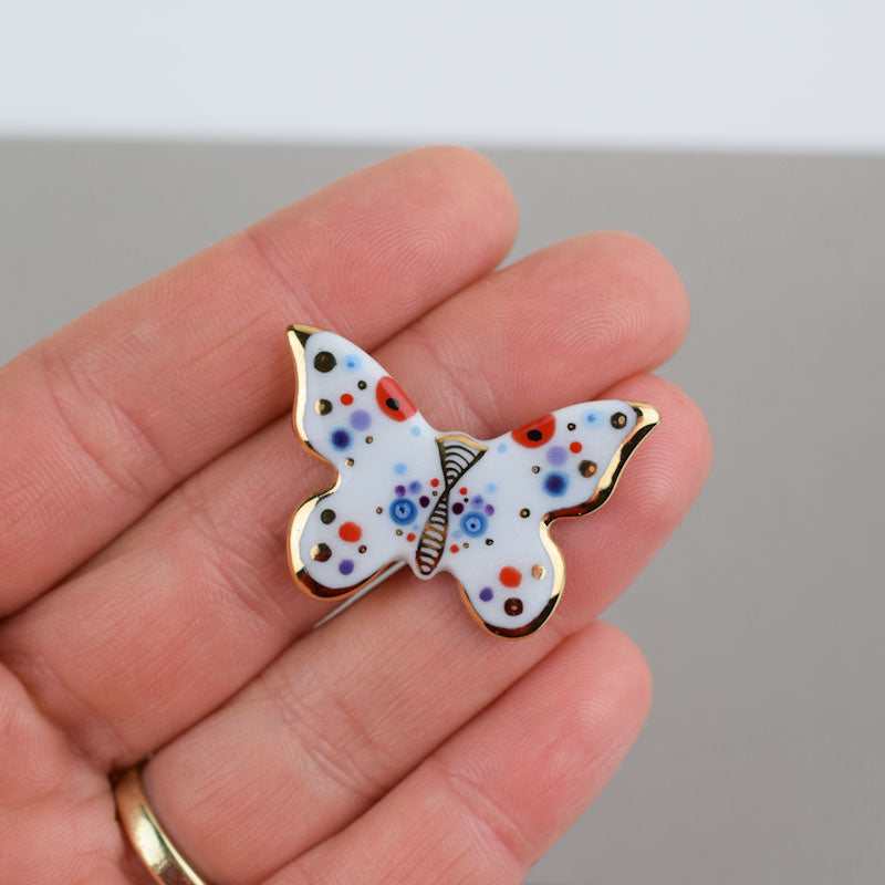 Butterfly. Porcelain brooch created and hand-painted by Vali Bondoc with high temperature ceramic dyes and colloidal gold
