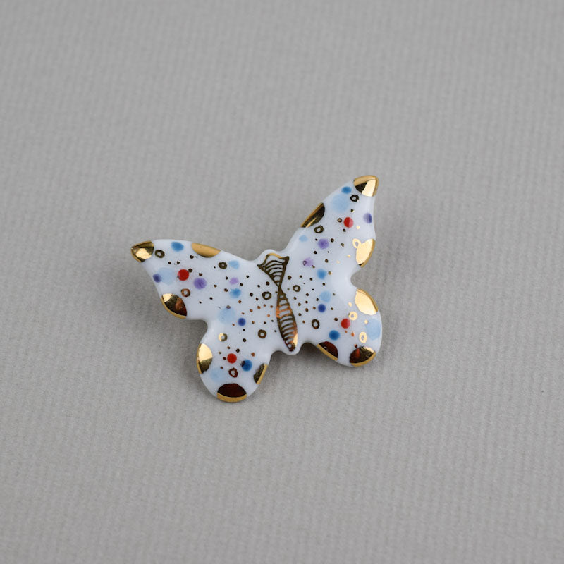 Butterfly. Porcelain brooch created and hand-painted by Vali Bondoc with high temperature ceramic dyes and colloidal gold