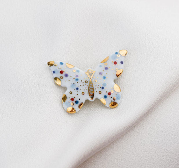 Butterfly. Porcelain brooch created and hand-painted by Vali Bondoc with high temperature ceramic dyes and colloidal gold