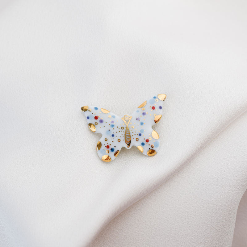 Butterfly. Porcelain brooch created and hand-painted by Vali Bondoc with high temperature ceramic dyes and colloidal gold