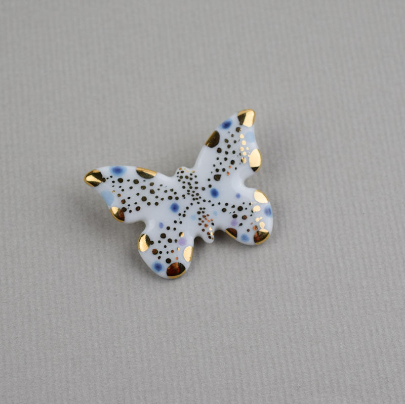 Butterfly. Porcelain brooch created and hand-painted by Vali Bondoc with high temperature ceramic dyes and colloidal gold