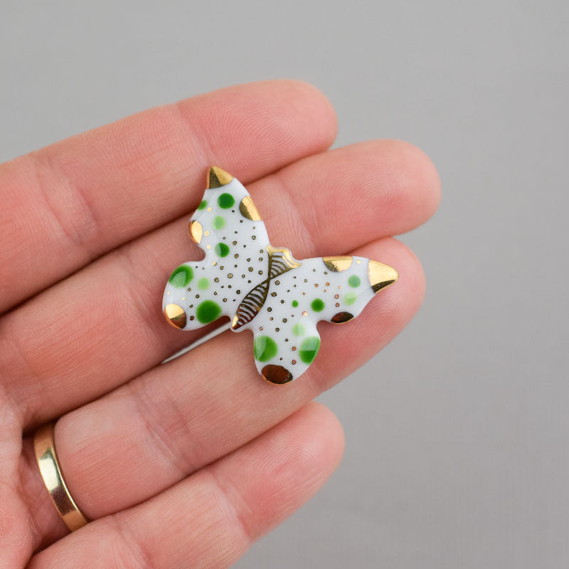 Butterfly. Porcelain brooch created and hand-painted by Vali Bondoc with high temperature ceramic dyes and colloidal gold