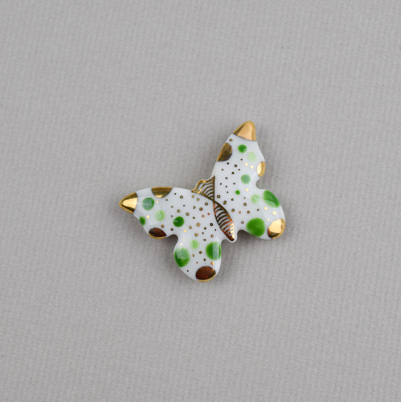 Butterfly. Porcelain brooch created and hand-painted by Vali Bondoc with high temperature ceramic dyes and colloidal gold