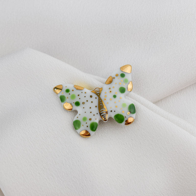 Butterfly. Porcelain brooch created and hand-painted by Vali Bondoc with high temperature ceramic dyes and colloidal gold