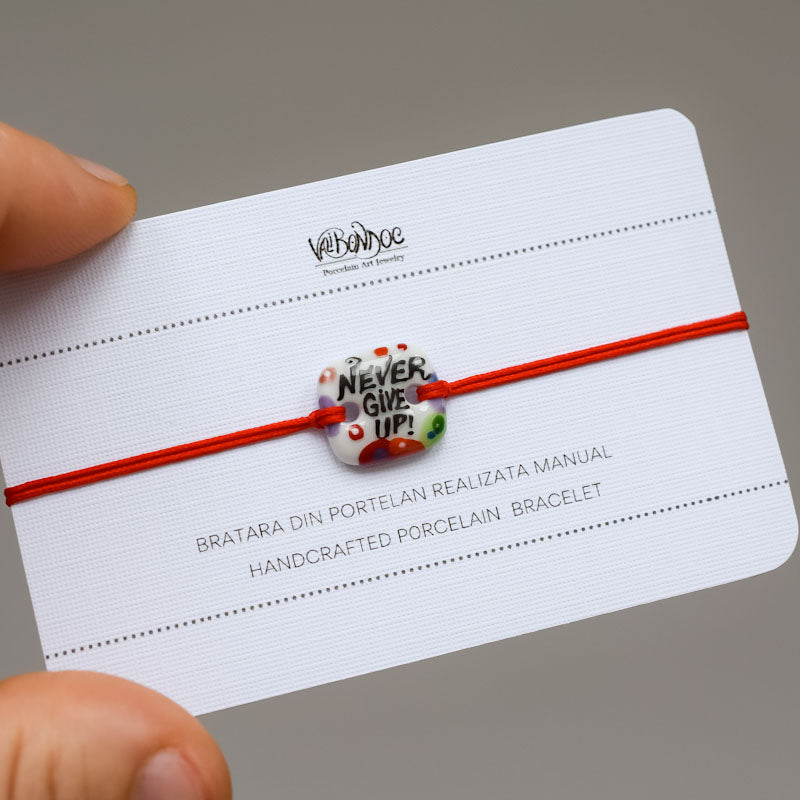 Never give up. Porcelain bracelet handmade and hand painted by Vali Bondoc