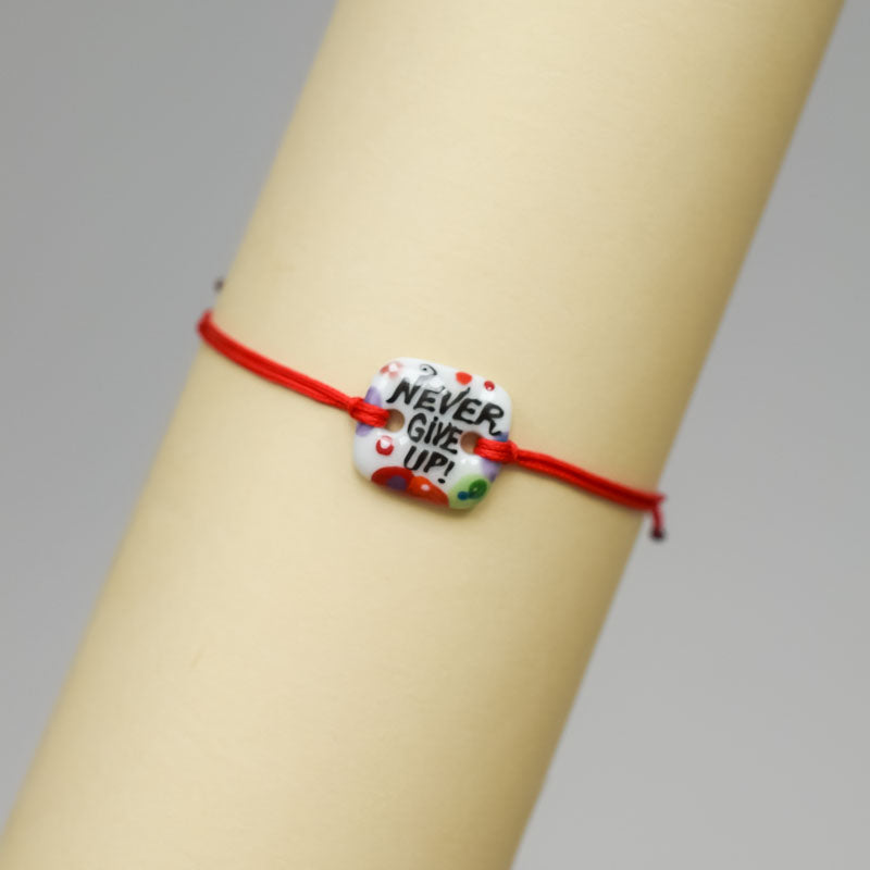 Never give up. Porcelain bracelet handmade and hand painted by Vali Bondoc