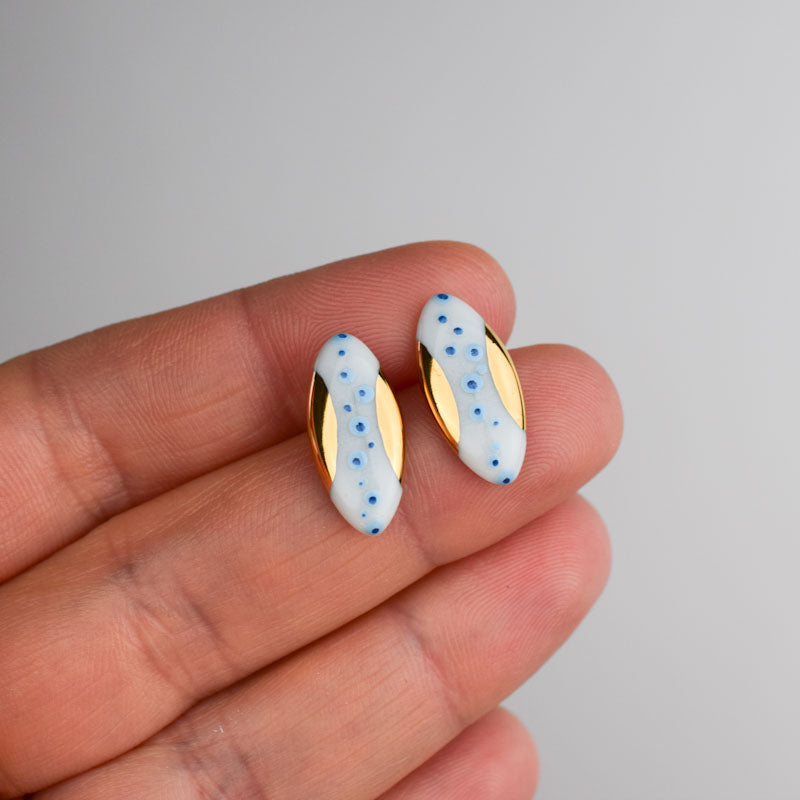 Porcelain stud earrings created and hand-painted by Vali Bondoc with high temperature ceramic dyes and colloidal gold